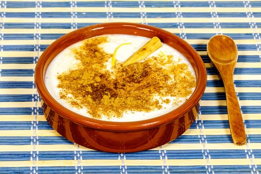 Dish of rice pudding with lemon scratches and with spoon