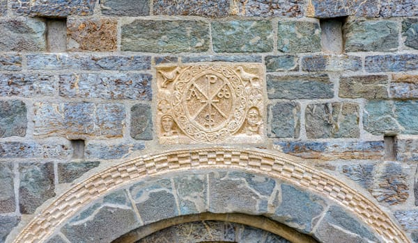 Roman Church of Santa Maria de la Asuncion in Coll, Catalonia - Spain. Detail of the cristogram on the outer cover