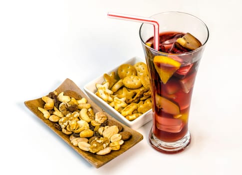 Refreshing typical sangria drink from Spain, with ice and fruits. With nuts