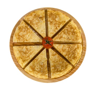 A triangle of potato Spanish omelette on a plate isolated background in white color