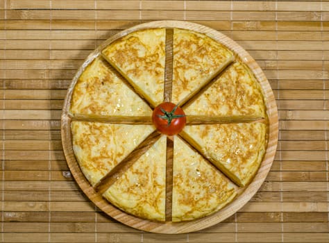 A triangle of potato Spanish omelette on a plate