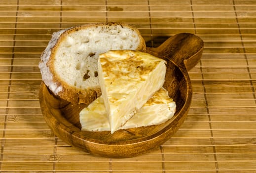 Spanish tortilla skewer presented in typical ration of Spain, With bread
