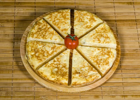 A triangle of potato Spanish omelette on a plate