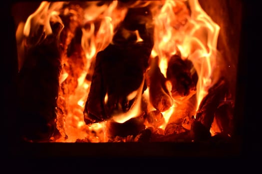 Hot coals in the stove. Red burned by heating the particles tree.