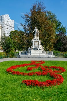 Mozart Statue with flower decoration in the form of a musical treble clef key, Vienna, Austria