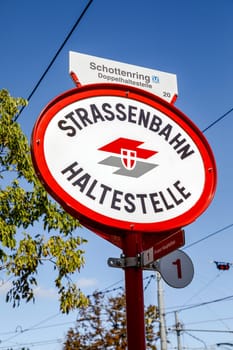 Vienna, Austria - September 16, 2019: Logo of Wiener Linien on a local tram stop (Strassenbahn Haltestelle) on Karlsplatz in Vienna