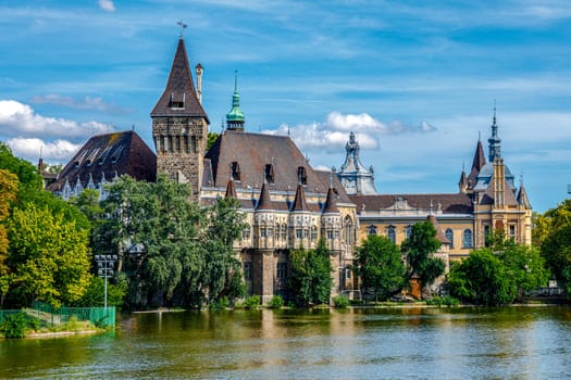 Budapest Vajdahunyad Castle viewed from its lakeside with two pretty young girls in a rowboat