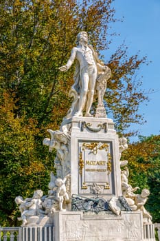 Mozart Statue with flower decoration in the form of a musical treble clef key, Vienna, Austria