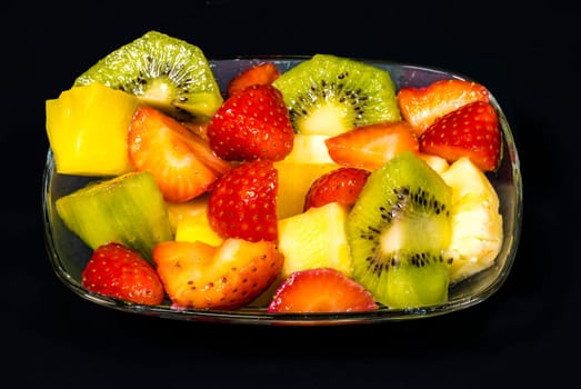 fresh fruit macedonia cut into cubes, Isolated background in black