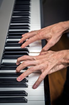 extremely thin hands pianist playing the keys of a piano