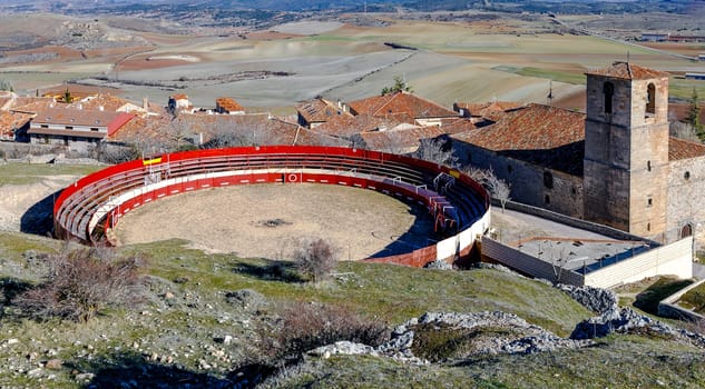 Bullring next to Holy Trinity Church and a view over Atienza town, Guadalajara, Spain