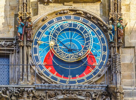 Prague, Czech republic - September 12, 2019: Beautiful big vintage clock with arrows and decorations in the form of figures and stucco in the center of Prague. Famous astronomical mechanical clock on tower in old town