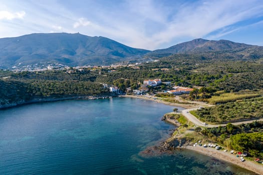 Port Lligat in Spain with a tree in the foreground. Port Lligat is a village located on the Costa Brava at northeastern Catalonia in Spain. Salvador Dali lived in the village.