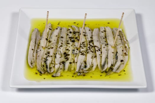 a pile of anchovies in vinegar isolated on a white background