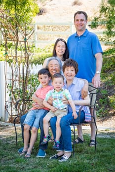Chinese and Caucasian Family Sitting on Bench.