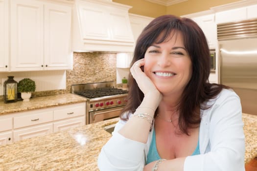 Attractive Middle Aged Woman Portrait Inside Kitchen At Home.