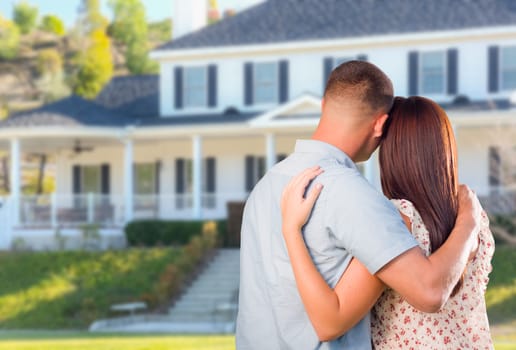 Affectionate Military Couple Looking at Beautiful New House.