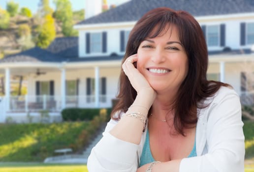 Attractive Middle Aged Woman Relaxing In Front Yard of Beautiful House.
