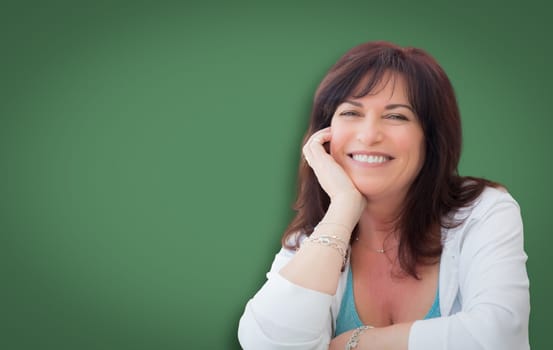 Attractive Middle Aged Woman Portrait In Front of Green Chalkboard.