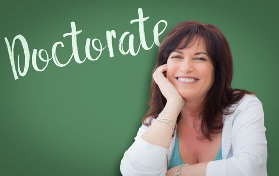 Doctorate Written On Green Chalkboard Behind Smiling Middle Aged Woman.