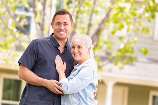 Happy Caucasian Couple in Front of House