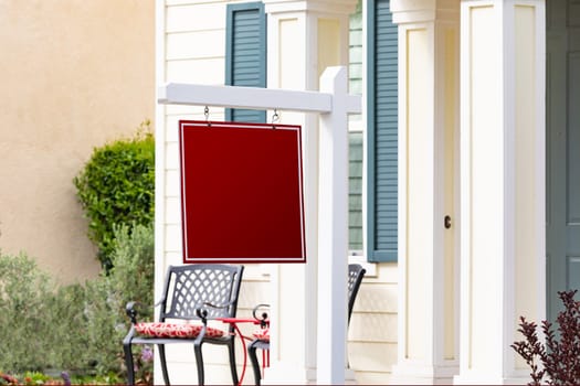 Blank Sale Real Estate Sign in Front of House.
