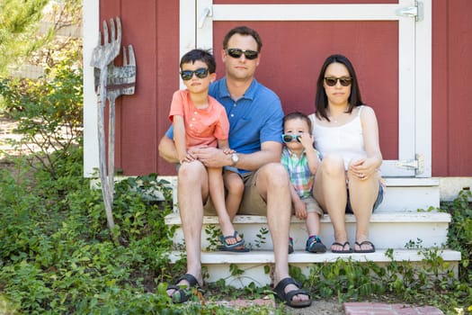 Portrait of Caucasian and Chinese Couple with Their Mixed Race Young Boys Wearing Sunglasses