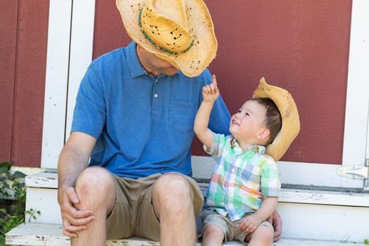 Playful Young Caucasian Father and Mixed Race Chinese Son Wearing Cowboy Hats