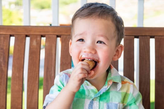 Young Mixed Race Chinese and Caucasian Boy Enjoying His Ice Cream Cone