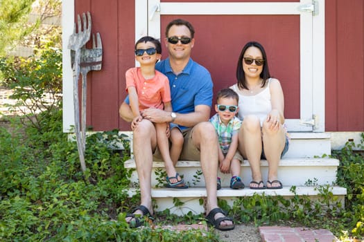 Portrait of Caucasian and Chinese Couple with Their Mixed Race Young Boys Wearing Sunglasses