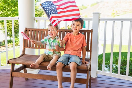Young Mixed Race Chinese and Caucasian Brothers Playing With American Flags