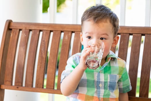 Mixed Race Chinese and Caucasian Boy Enjoying A Glass Of Water