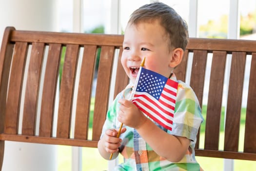 Young Mixed Race Chinese and Caucasian Boy Playing With American Flag