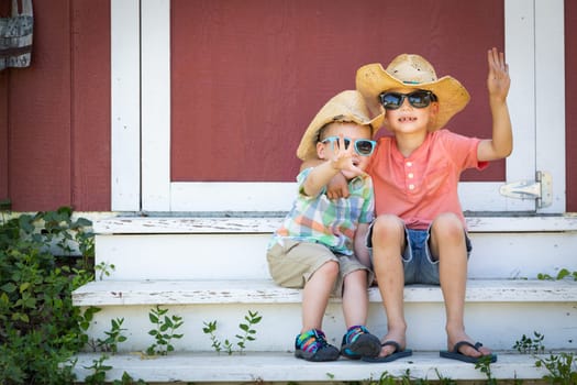 Mixed Race Chinese and Caucasian Young Brothers Having Fun Wearing Sunglasses and Cowboy Hats