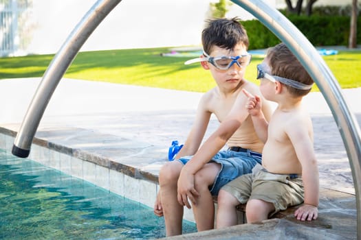 Young Mixed Race Chinese and Caucasian Brothers Wearing Swimming Goggles Playing At The Pool