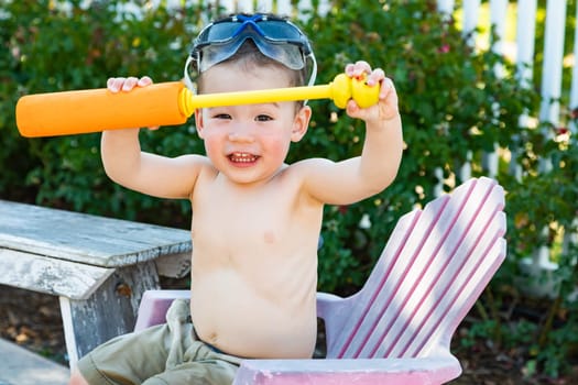 Happy Playful Young Mixed Race Chinese and Caucasian Boy Wearing Swimming Goggles