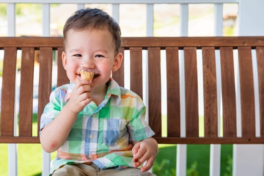 Young Mixed Race Chinese and Caucasian Boy Enjoying His Ice Cream Cone