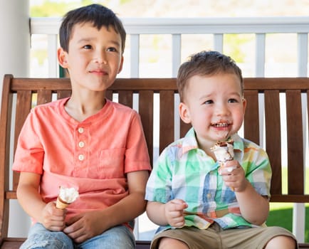 Young Mixed Race Chinese and Caucasian Brothers Enjoying Their Ice Cream Cones