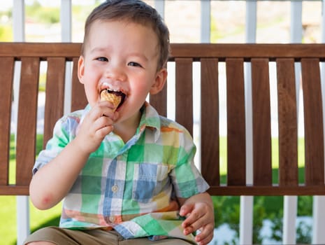 Young Mixed Race Chinese and Caucasian Boy Enjoying His Ice Cream Cone