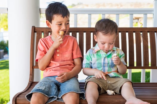 Young Mixed Race Chinese and Caucasian Brothers Enjoying Their Ice Cream Cones