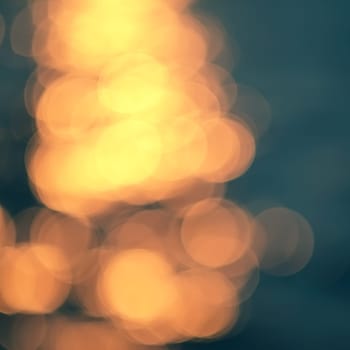 Golden sunlights on blue water background.