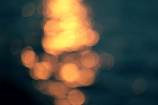 Golden sunlights on blue water background.