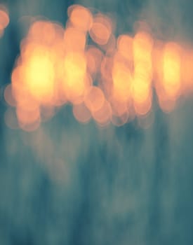 Golden sunlights on blue water background.
