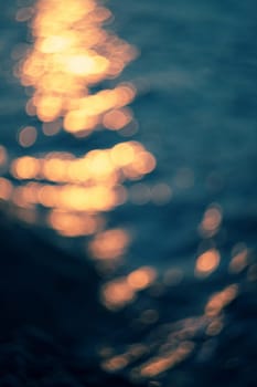 Golden sunlights on blue water background.