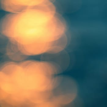 Golden sunlights on blue water background.