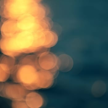 Golden sunlights on blue water background.