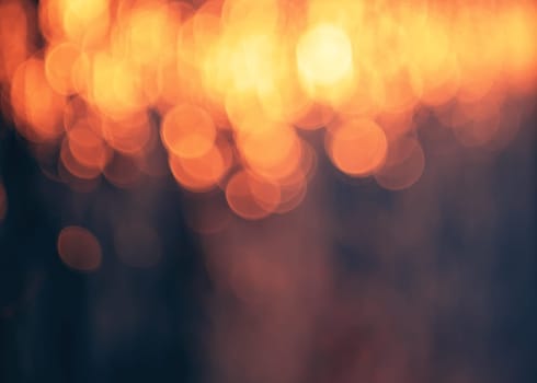 Purple and blue bokeh background.Orange lights.