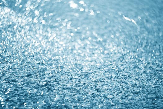Sea and stones background.Lights on blue background.Underwater.