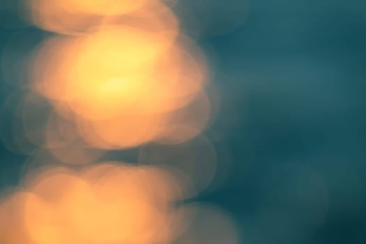 Golden sunlights on blue water background.