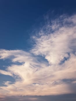 Tranquil evening cloudscape scene over the blue sky. Fluffy white clouds aerial composition. Misty overcast cumulus shapes, abstract nebula textures. Air fresheners, celestial beauty, vertical background